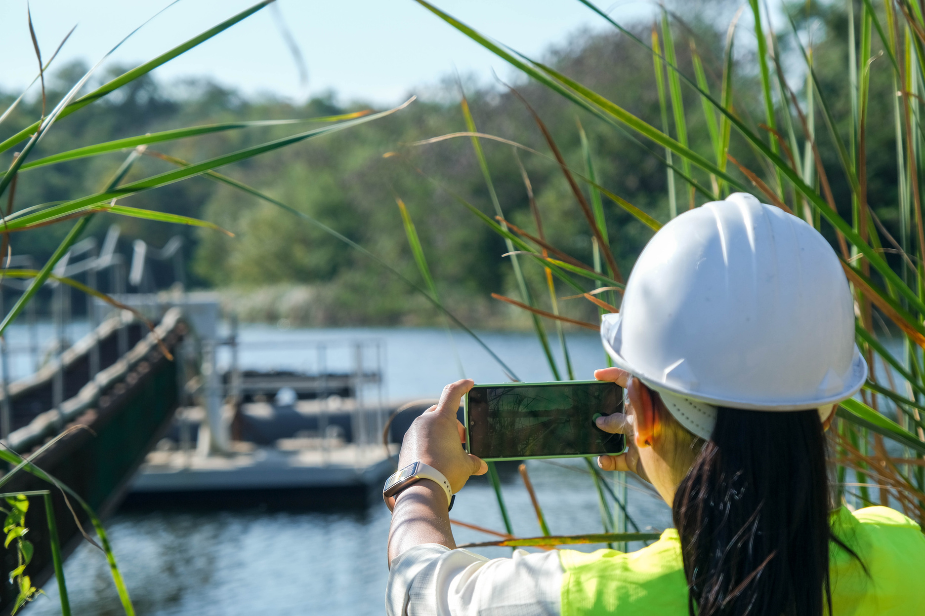 Environmental engineer uses a mobile phone to take pictures and